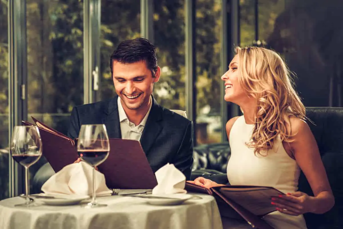 Cheerful couple with menu in a restaurant | How Many Ways Can You Say Happy Birthday to a Techie? | Happy Birthday Techie