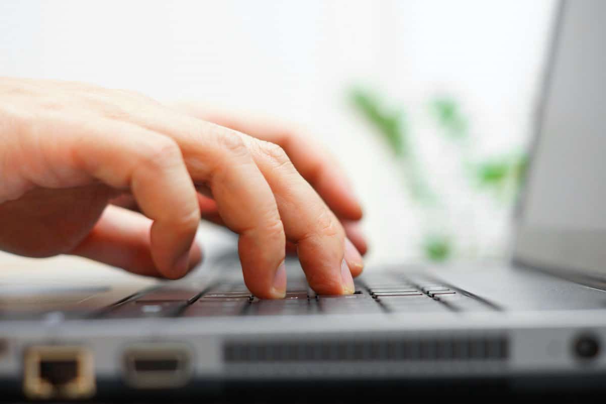 male hands typing on laptop | Sign Up For Gmail | A Comprehensive New User Guide | sign up for Gmail | sign in gmail