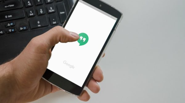 person using smartphone | What Is Google Hangouts? Your Questions, Answered | what is google hangouts | Google | Featured