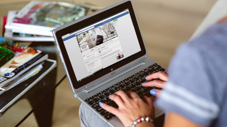 Featured | Woman typing on the notebook | How To Make A Facebook Business Page