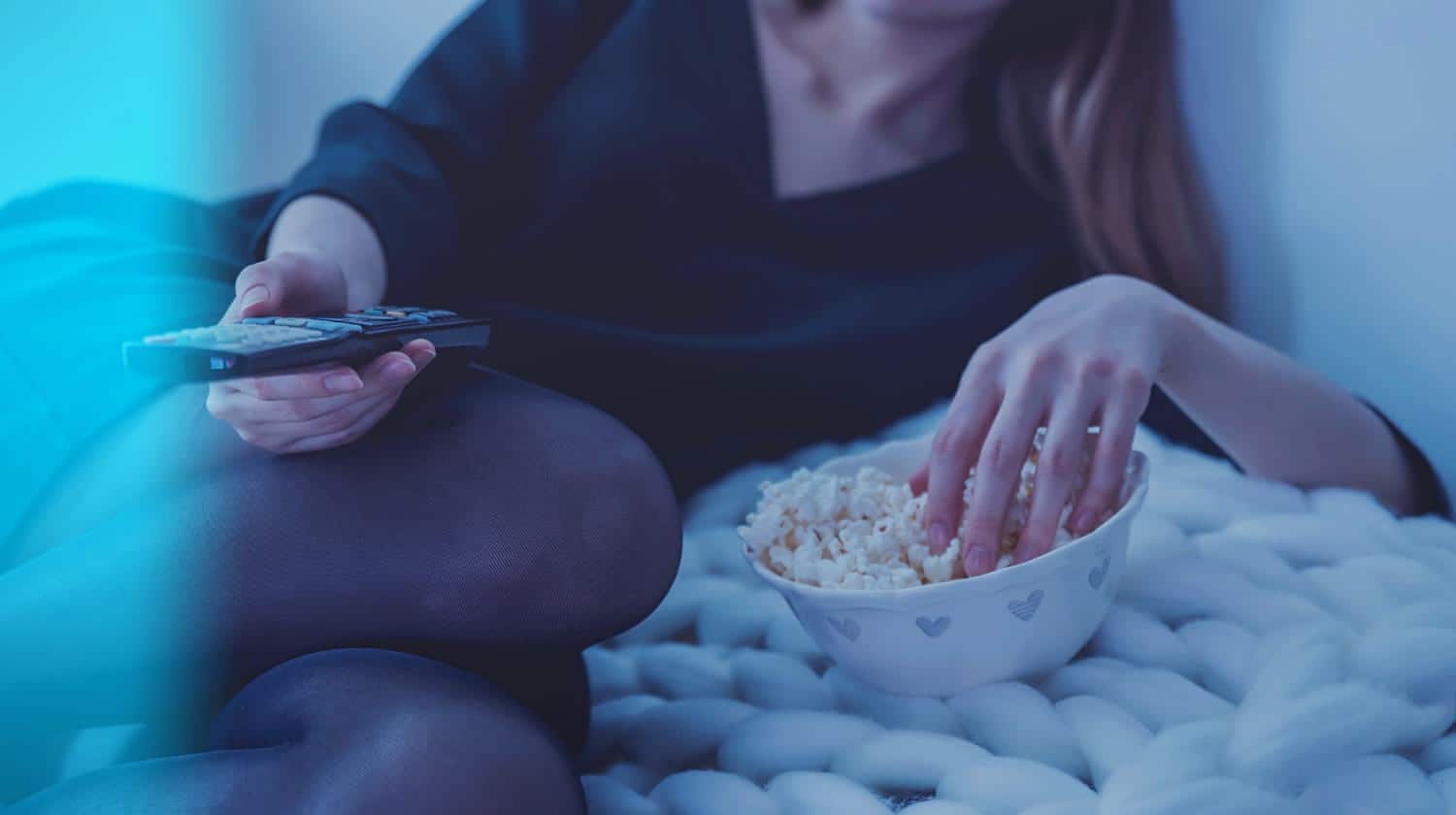 woman with popcorn | Feature | What Is Netflix? | Netflix Frequently Asked Questions | netflix subscription | netflix website | netflix account