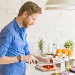 Feature | Young man chopping vegetables | How to Make Alexa Your Sous Chef | sou | alexa sous vides chef app