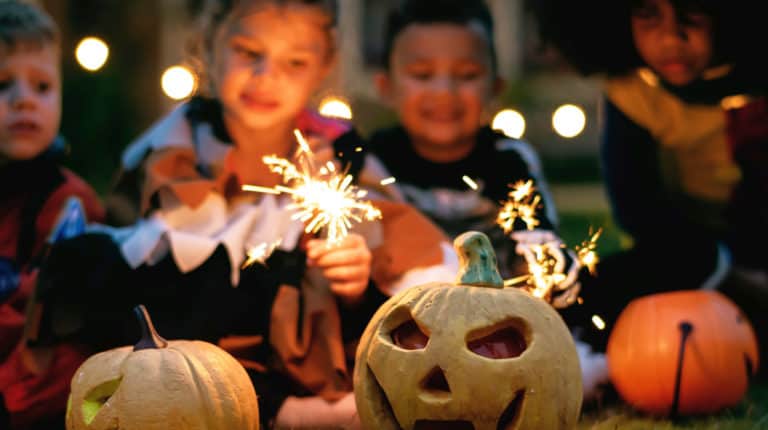 Feature | Children holding firecrackers outdoor | Best Kid Tracker Apps | Track Your Kids While Trick Or Treating