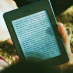 Feature | person reading kindle outdoor | Bestselling Amazon Kindle Books Of 2018