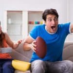 Man and woman watching football