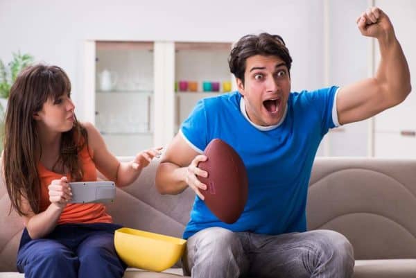 Man and woman watching football