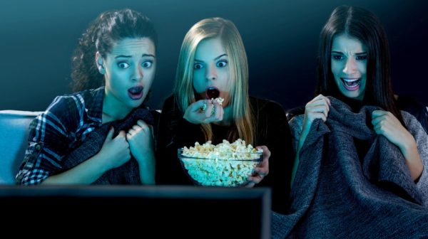 Feature | teenage girls watching horror movie | Best Horror Movies of All Time