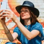 Feature | woman using her iPhone | iPhone XR, XS, and XS Max | Difference Between The Latest iPhone Models