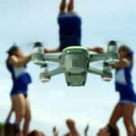 Feature | Flying drone with cheerleader on background | Dji Spark | 7 Most Popular Drone Reviews