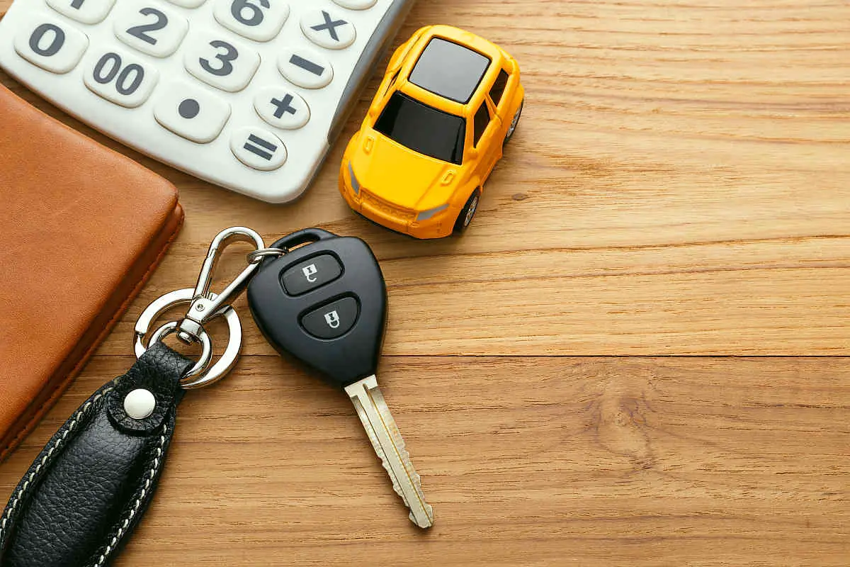 Car key and calculator on wooden table | There's An App For That | Phone Apps For Anything and Everything
