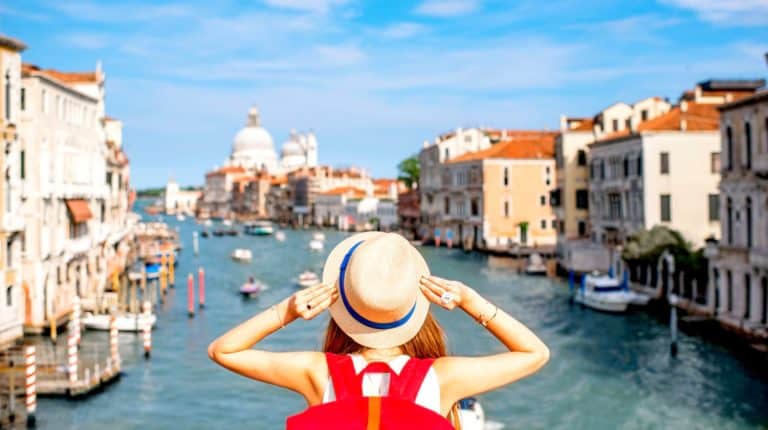 Feature | woman on the grand canal | Awesome Travel Apps That Can Help You Find the Best Vacation Spots