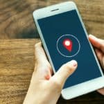 Feature | Holding smartphone showing location | Location Tracking On Smartphones: How Does It Work?