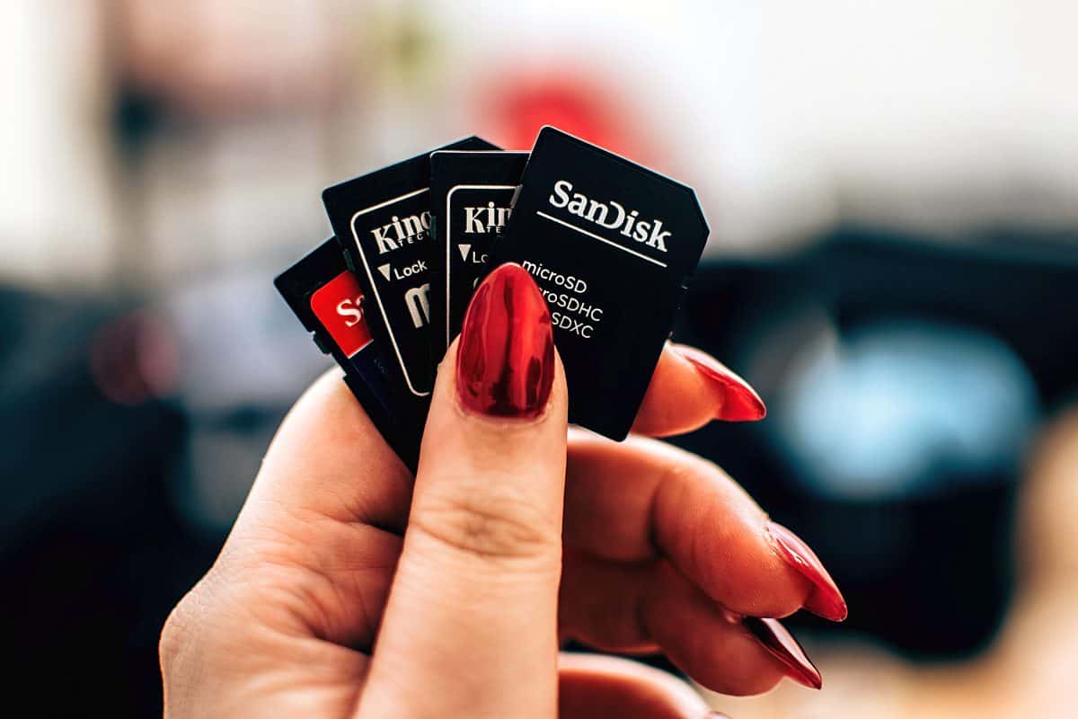 Woman holding memory cards | Choosing The Right Memory Card For All Your Gadgets