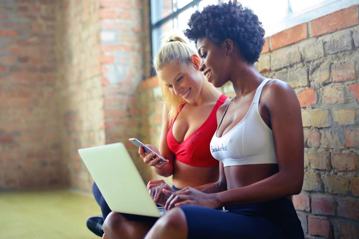 two women wearing sports bra | What Is A Mobile Hotspot? The Pros And Cons Unveiled | wi-fi hotspot | data | phone