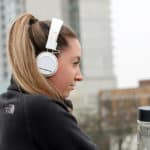 Feature | Woman black black jacket with white headphone | Must-Have Wireless Tech Gadgets That Will Make Your Life Easier | Wireless Technology