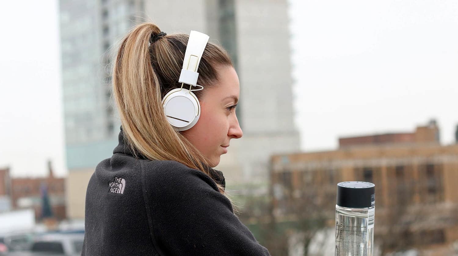 Feature | Woman black black jacket with white headphone | Must-Have Wireless Tech Gadgets That Will Make Your Life Easier | Wireless Technology