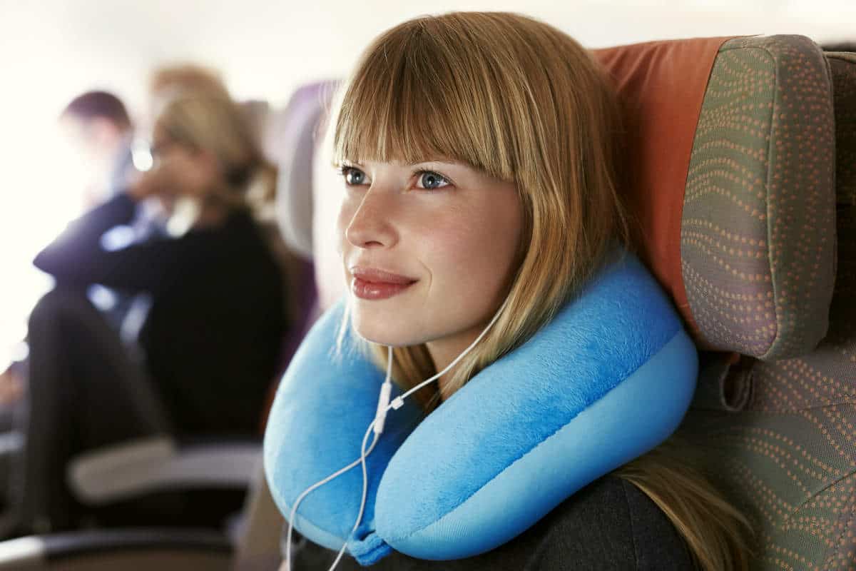 Beautiful female passenger on airplane | Travel Tips For The Newbie International Traveler