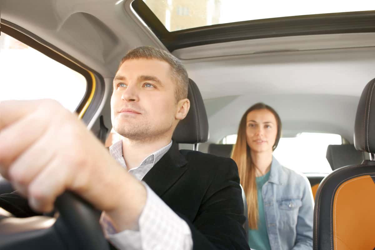 Male driver and female passenger in car | Travel Tips For The Newbie International Traveler