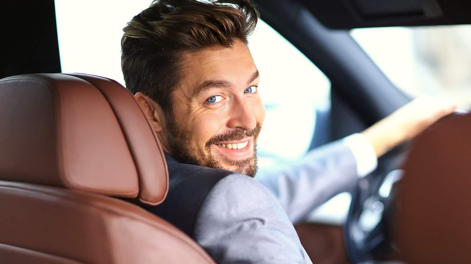Feature | Portrait of an handsome smiling business man driving his car | Cool Car Gadgets On Amazon