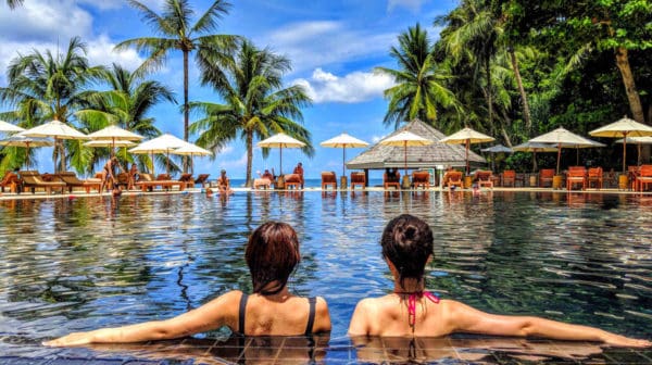 Feature | Two woman on Infinity pool | Waterproof Gadgets To Lounge By The Pool With