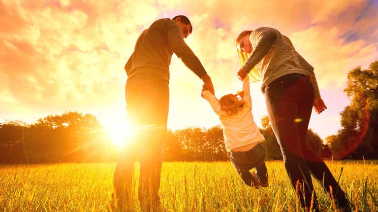Feature | Happy family in the park evening light | Best Family Safety Gadgets, Apps and Digital Books