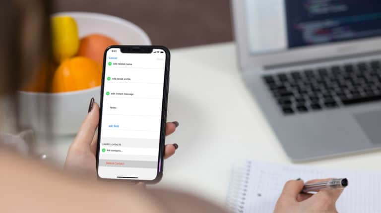 Feature | Person holding iphone | How To Delete Multiple Contacts On Your iPhone Easily
